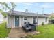 Outdoor living space with a cozy patio setup, perfect for entertaining and relaxation at 305 W Vinyard St, Anderson, IN 46011