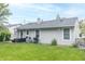 Spacious backyard featuring lush green grass, a wooden deck, and modern appliances, perfect for outdoor enjoyment at 305 W Vinyard St, Anderson, IN 46011