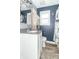 Bathroom featuring wood-look floors, updated vanity with lighting and mushroom shower curtain at 305 W Vinyard St, Anderson, IN 46011