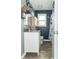 This bathroom features a white vanity, gray walls, and wood-look flooring, creating a modern and clean design at 305 W Vinyard St, Anderson, IN 46011