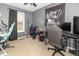 A bedroom with exercise equipment, a gaming desk, chair, and natural light at 305 W Vinyard St, Anderson, IN 46011