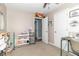 Bedroom with open door, crafting and sewing supplies, shelves and a side table at 305 W Vinyard St, Anderson, IN 46011