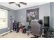 A bedroom with a gaming desk, chair, and natural light from a window at 305 W Vinyard St, Anderson, IN 46011