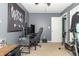 A bedroom with exercise equipment, a gaming desk, chair, and natural light at 305 W Vinyard St, Anderson, IN 46011