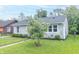 Beautiful front yard with lush green grass, mature tree, and tidy landscaping enhancing the home's appeal at 305 W Vinyard St, Anderson, IN 46011