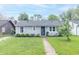 Charming home with well-maintained lawn, inviting walkway, and neatly trimmed bushes enhancing its curb appeal at 305 W Vinyard St, Anderson, IN 46011
