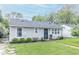 Charming single-story home with a well-manicured lawn and neatly trimmed shrubbery at 305 W Vinyard St, Anderson, IN 46011