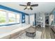 Bright living room with large windows, ceiling fan, and cozy seating area, creating a welcoming atmosphere at 305 W Vinyard St, Anderson, IN 46011