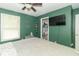 An ample main bedroom with calming paint, a ceiling fan and storage at 305 W Vinyard St, Anderson, IN 46011