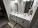 Bright bathroom features a double sink vanity with shaker cabinets and wood look tile floors at 308 Bay Ridge Dr, Pendleton, IN 46064