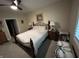 Cozy carpeted bedroom featuring decorative metal bedframe, window, and a ceiling fan at 308 Bay Ridge Dr, Pendleton, IN 46064
