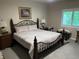 Comfortable bedroom with neutral walls, carpet, and a decorative metal bed frame at 308 Bay Ridge Dr, Pendleton, IN 46064