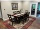 Cozy dining room with a wooden table set for six and a sliding glass door at 308 Bay Ridge Dr, Pendleton, IN 46064