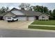 Charming single-story home with a brick facade, three-car garage, and well-manicured lawn at 308 Bay Ridge Dr, Pendleton, IN 46064
