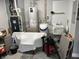 Garage featuring a utility sink, water heater, and ample space for various household needs at 308 Bay Ridge Dr, Pendleton, IN 46064
