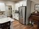 Modern eat in kitchen features stainless fridge, white cabinets, and stone countertops at 308 Bay Ridge Dr, Pendleton, IN 46064