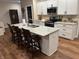 Eat in kitchen island features white cabinets, stone countertops, and counter height seating at 308 Bay Ridge Dr, Pendleton, IN 46064