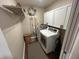 Functional laundry room with white cabinets, shelving, and modern washer and dryer at 308 Bay Ridge Dr, Pendleton, IN 46064