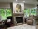 Relaxing living room with a brick fireplace, comfortable seating, and ample natural light at 308 Bay Ridge Dr, Pendleton, IN 46064