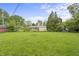 Expansive backyard featuring a large grassy area and mature trees, perfect for outdoor activities and relaxation at 3526 Westfield Dr, Anderson, IN 46011