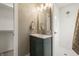 Bathroom features a green vanity, gold fixtures, walk-in shower, and elegant mirror at 3526 Westfield Dr, Anderson, IN 46011