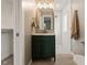 Bathroom features a green vanity, gold fixtures, walk-in shower, and elegant mirror at 3526 Westfield Dr, Anderson, IN 46011