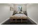 This light-filled bedroom features a black frame bed and plush bench at 3526 Westfield Dr, Anderson, IN 46011