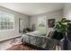 This spacious bedroom features warm wood floors and a lush green comforter at 3526 Westfield Dr, Anderson, IN 46011
