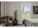 Cozy bedroom space showcasing a window and decorative wicker chair at 3526 Westfield Dr, Anderson, IN 46011