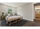 Light-filled bedroom featuring a view into the modern ensuite bathroom at 3526 Westfield Dr, Anderson, IN 46011