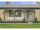 Inviting covered front porch featuring an overhang supported by columns and hanging flower baskets at 3526 Westfield Dr, Anderson, IN 46011