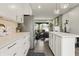 Open kitchen flowing into a living space, featuring white cabinetry and stainless steel appliances at 3526 Westfield Dr, Anderson, IN 46011