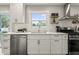 Modern kitchen features stainless steel appliances, white cabinets, and a bright window overlooking the backyard at 3526 Westfield Dr, Anderson, IN 46011