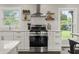 Bright kitchen featuring stainless steel range, decorative shelving, and a window view at 3526 Westfield Dr, Anderson, IN 46011
