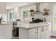 Modern kitchen showcasing white cabinets, stainless steel appliances, and decorative open shelving at 3526 Westfield Dr, Anderson, IN 46011