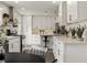 Open kitchen design boasts white cabinets, pendant lighting, bar seating, and modern stainless steel appliances at 3526 Westfield Dr, Anderson, IN 46011