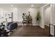 Inviting living room featuring a sleek chair, modern shelving, and dark hardwood floors at 3526 Westfield Dr, Anderson, IN 46011