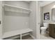 Mud room features a bench and shelf for storage, alongside a half bathroom at 3526 Westfield Dr, Anderson, IN 46011
