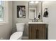 Cozy powder room features a wooden vanity, black fixtures, and unique tiger art at 3526 Westfield Dr, Anderson, IN 46011