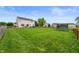 Large backyard with green grass, wood fence, trampoline and plenty of space for entertaining at 3638 Fieldstone Ln, Plainfield, IN 46168