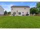 Well-manicured backyard features green grass, wood fence, patio area with furniture and BBQ grill at 3638 Fieldstone Ln, Plainfield, IN 46168
