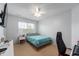 Bright bedroom with a bed, desk, and window offering natural light at 3638 Fieldstone Ln, Plainfield, IN 46168