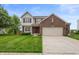 Inviting two-story home featuring a brick facade, attached two-car garage, and well-manicured lawn at 3638 Fieldstone Ln, Plainfield, IN 46168