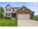 Inviting two-story home featuring a brick facade, attached two-car garage, and well-manicured lawn at 3638 Fieldstone Ln, Plainfield, IN 46168