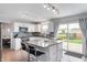 Open-concept kitchen with white cabinets, stainless steel appliances, and access to the backyard at 3638 Fieldstone Ln, Plainfield, IN 46168
