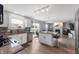 Bright kitchen with white cabinets, stainless steel appliances, a granite island with seating, and a view to the backyard at 3638 Fieldstone Ln, Plainfield, IN 46168
