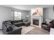 Comfortable living room with a fireplace, plush sofa, accent chair, and neutral decor at 3638 Fieldstone Ln, Plainfield, IN 46168