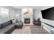 Comfortable living room featuring a fireplace, plush sofa, accent chair, and neutral decor at 3638 Fieldstone Ln, Plainfield, IN 46168