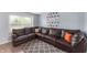 Spacious living room featuring a large corner sofa, neutral walls, and a bright window at 3638 Fieldstone Ln, Plainfield, IN 46168