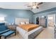 Cozy main bedroom featuring a bed with storage, chair, and spacious closet at 3638 Fieldstone Ln, Plainfield, IN 46168